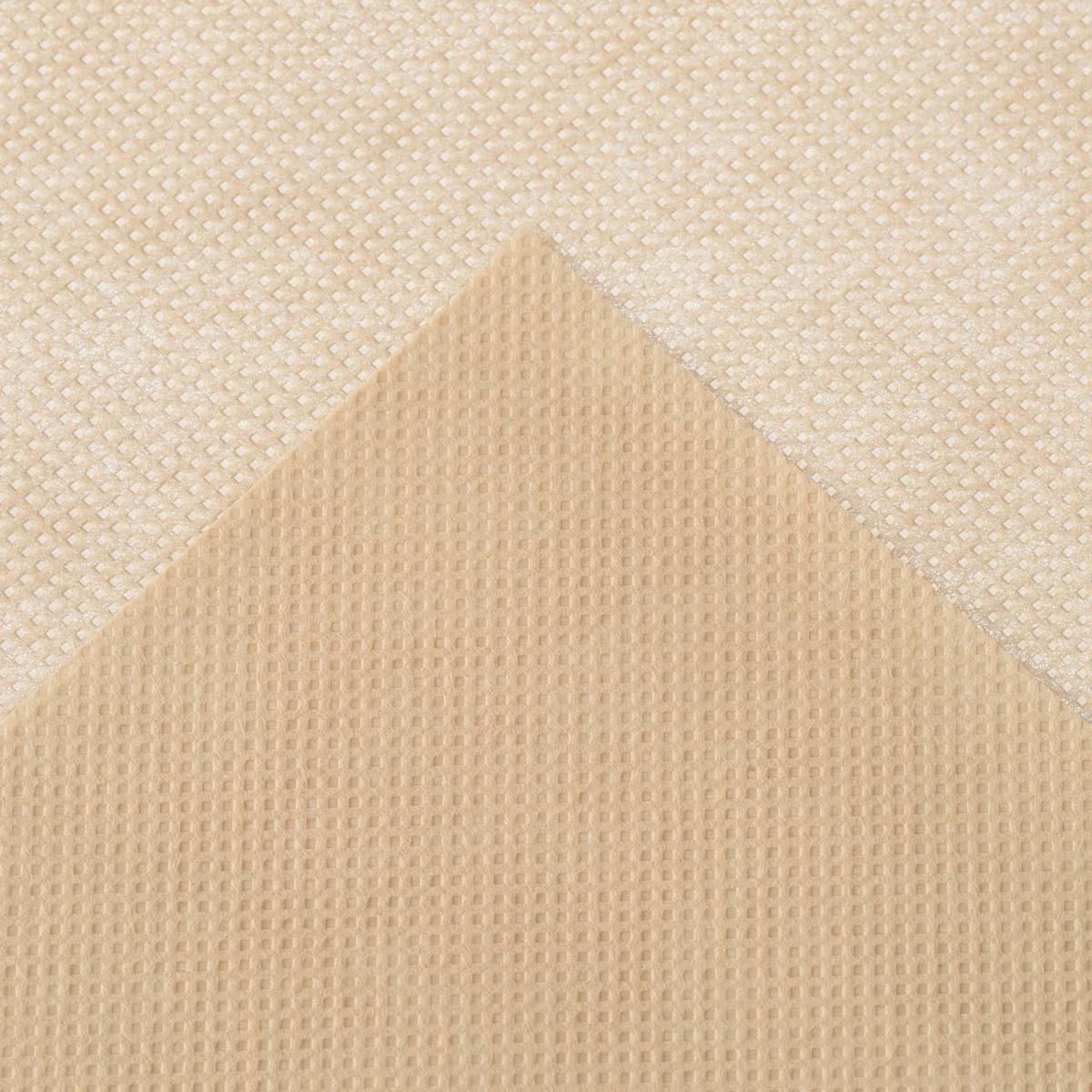Nærbillede af beige nonwoven klud med mønster
