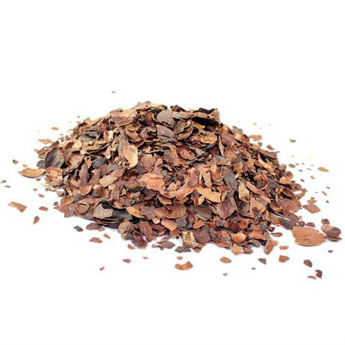 Bunke tørrede kakaoskaller på hvid baggrund